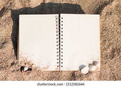 Blank page notepad and seashell on a sandy beach on a holiday. - Powered by Shutterstock