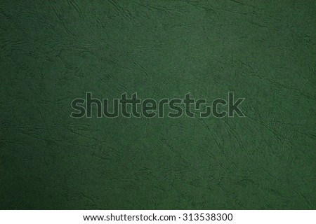 Blank page still life paper texture background with leather lines markings effect, full frame. Close up detail of textured sheet of green color organic art paper. Background rough wall emerald color.