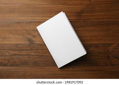 Blank Paper Brochure On Wooden Table, Top View. Mockup For Design