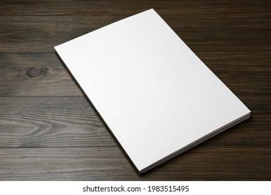 Blank Paper Brochure On Wooden Table. Mockup For Design