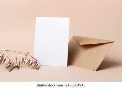 Blank paper card mockup with envelope and dry botanical decor, white card with copy space