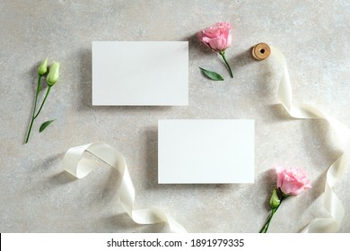 Blank Paper Cards, Flowers, Ribbon On Stone Table. Wedding Invitation Cards Templates. Flat Lay. Top View.