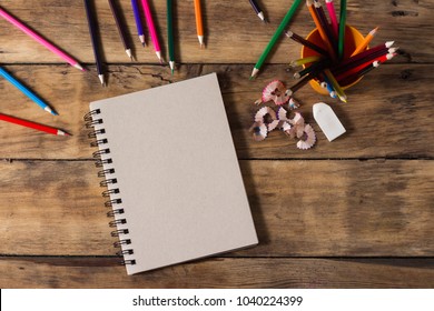 Blank paper and colorful pencils on old wooden table. Flat lay, top view. - Powered by Shutterstock