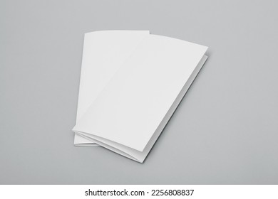 Blank paper folded on gray background - Shutterstock ID 2256808837