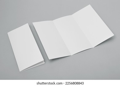 Blank paper folded on gray background - Shutterstock ID 2256808843