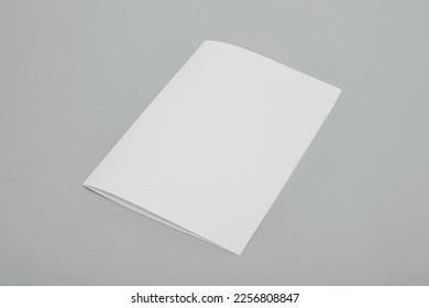 Blank paper folded on gray background - Shutterstock ID 2256808847