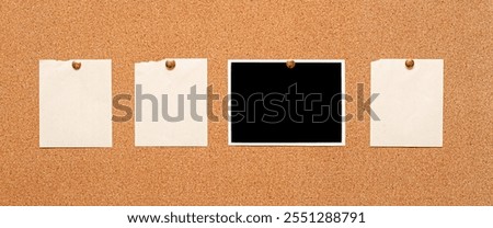 Blank paper notes and an empty photo are pinned to a cork board. The concept of detective investigation.