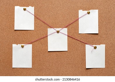 Blank paper notes are pinned to a cork board. The concept of detective investigation. Copy space. - Shutterstock ID 2130846416