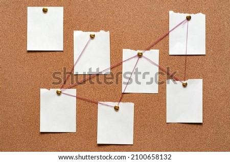 Blank paper notes are pinned to a cork board. The concept of detective investigation. Copy space. Сток-фото © 