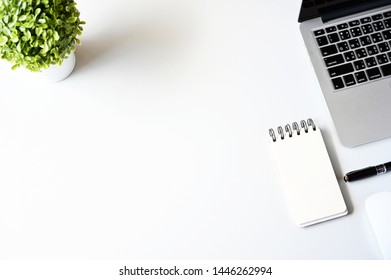 Blank paper Note,Succulent,Laptop computer and pen on wooden table with copy space