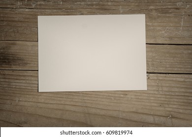 Blank paper on wood table - Shutterstock ID 609819974