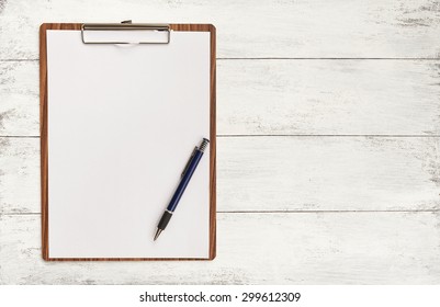 Blank paper on wooden clipboard with space on background