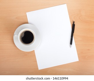 Blank Paper With Pen And Coffee Cup On Wood Table