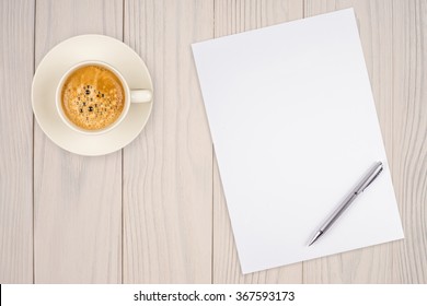 Blank Paper With Pen And Coffee Cup On Wood Table