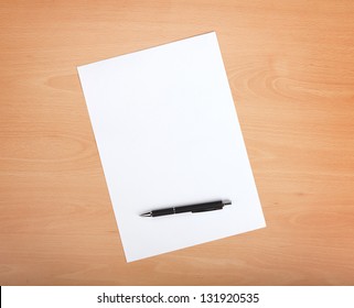 Blank Paper With Pen On Wood Table