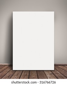 Blank Paper Poster Mock Up Leaning Against  Gray Wall as Copy Space for Design and Text.