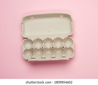 blank paper rectangular tray for chicken eggs on pink background, top view