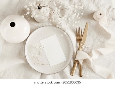 Blank paper sheet card mockup on minimal table place setting top view on beige linen tablecloth.  Space for text. Wedding invitation, menu. Scandinavian style. - Shutterstock ID 2051805035