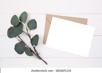 Blank Paper Sheet Copy Space With Mockup And Leaf On Wooden Table, Card, Poster And Envelope, Postcard Decoration Your Design Or Branding, Simplicity And Minimal, Nobody, Flat Lay, Top View.