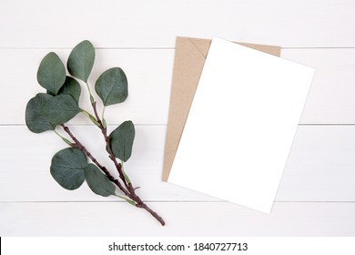 Blank Paper Sheet Copy Space With Mockup And Leaf On Wooden Table, Card, Poster And Envelope, Postcard Decoration Your Design Or Branding, Simplicity And Minimal, Nobody, Flat Lay, Top View.