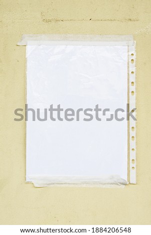 Blank paper in sleeve taped to a wall