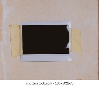 Blank photo frame with scotch tape isolated on old paper background as template for graphic designers presentations, portfolios