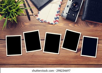 Blank Photo Frames, Camera And Supplies On Wooden Table. Top View. Toned