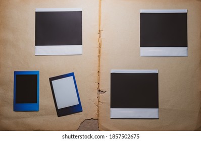 Blank photo frames on book background as template. Top View of photo frame, memory of a trip or adventure. Photo card with space for your logo or text.  - Shutterstock ID 1857502675