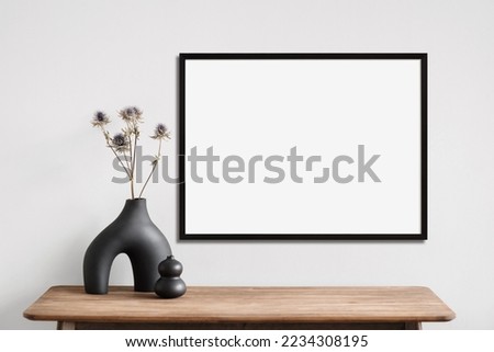 Blank picture frame mockup on a wall. Landscape orientation. Artwork template in interior design