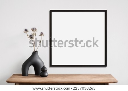 Blank picture frame mockup on a wall. Square orientation. Artwork template in interior design