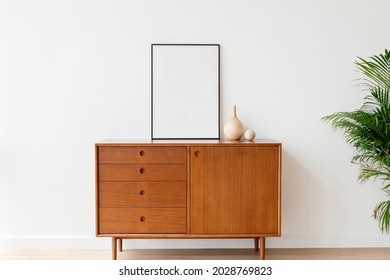 Blank picture frame on a wooden cabinet - Shutterstock ID 2028769823