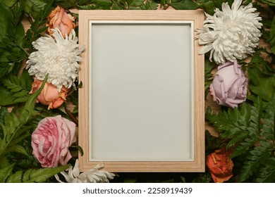 Blank picture frame surrounded by colorful spring flower and green leaves. Floral frame, spring or summer background - Powered by Shutterstock