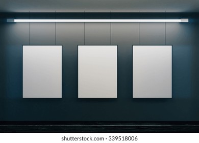 Blank Picture Frames On Grey Wall With Glowing Lamp, Mock Up