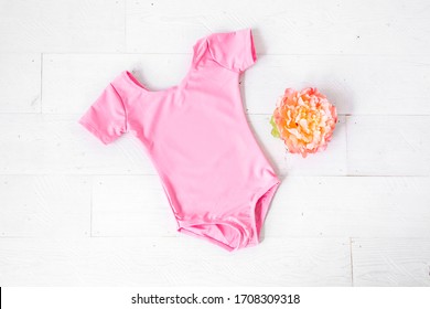 Blank pink girl's leotard on white background with flower, dance/ballet/gymnastics short sleeve apparel mockup