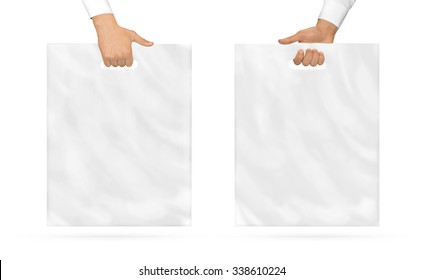Blank plastic bag mock up holding in hand. Empty polyethylene package mockup hold in hands isolated on white. Pack ready for logo design or mall identity presentation. Food shopping packet handle.