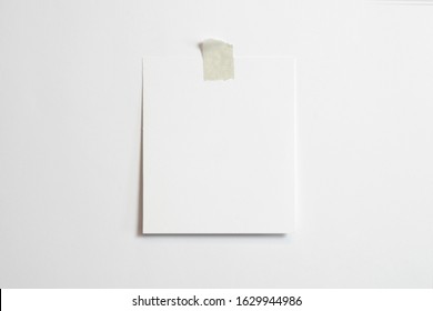 Blank polaroid photo frame with soft shadows  and scotch tape isolated on white paper background as template for graphic designers presentations, portfolios etc.