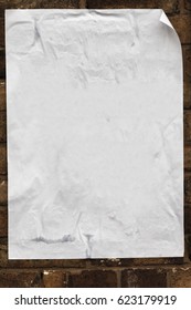 Blank Poster Texture, Crumpled, Creased Curled At The Edges Pasted On To A Brick Wall.