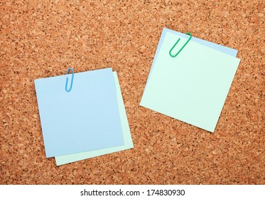 Blank postit notes on cork wood notice board