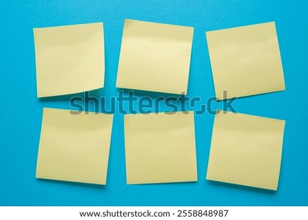 Blank post-it notes stuck in order on a blue background