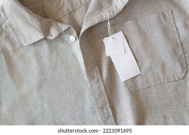 Blank Price Label Tag Paper Card On Natural Linen Shirt. Clothes Label Tag Mockup Template With Copy Space For Brand, Text, Price. Top View, Copy Space