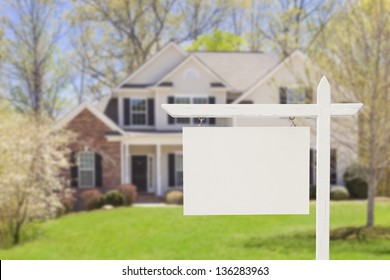 Blank Real Estate Sign in Front of Beautiful New House.