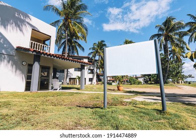 Blank Real Estate Sign In Front Of Beautiful New House. Space For Text Or Advertising. Mockup