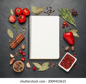 Blank Recipe Book And Different Ingredients On Black Table, Flat Lay. Space For Text