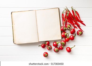 Blank Recipe Book And Hot Chili Peppers. Top View.