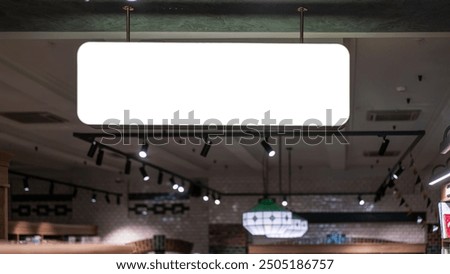 Blank rectangular sign with white space for mockup information hanging from ceiling inside modern retail store.
