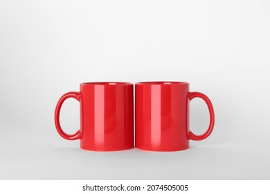 Blank red ceramic mugs on light background - Powered by Shutterstock