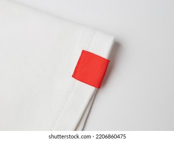 blank red color clothing label on white t shirt sleeve - Shutterstock ID 2206860475