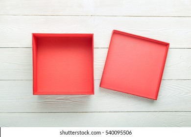 Blank Red Gift Box With Lid On White Wooden Background. Flat Lay. View From Above