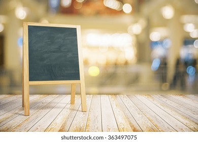 Blank restaurant blackboard on wooden floor, mock up