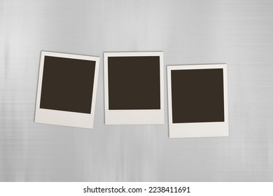 Blank retro photo frames on desk. - Shutterstock ID 2238411691